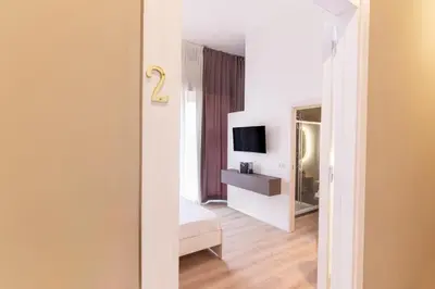 a bedroom with a bed and a television in a room at Diletti Rooms in Palermo