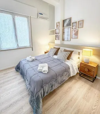 a bedroom with a large bed with towels on it at Diletti Rooms in Palermo