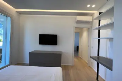 a bedroom with a bed and a tv on a wall at Villa Ippolita - 2 Bedrooms Apartment with Exclusive Garden in San Vito lo Capo
