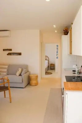 a kitchen and a living room with a couch at Villa Ippolita - 2 Bedrooms Apartment with Terrace & Garden Exclusive in San Vito lo Capo