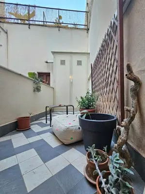 a balcony with potted plants on the floor of a building at RoccoLima in Palermo