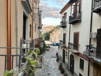 a kitchen and living room with a table and a stove at RoccoLima in Palermo