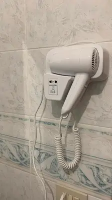 a white phone is hanging on a wall at Casa Paradiso in Palazzo Adriano