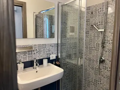a bathroom with a sink and a shower at Ricasoli28Apartaments in Palermo