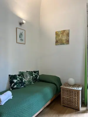 a green couch in a room with a table at Ricasoli28Apartaments in Palermo