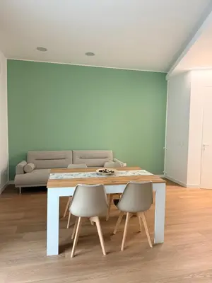 a kitchen with white cabinets and a sink and a microwave at Casa Salvia in Alcamo