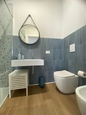a bedroom with a bed with a green wall at Casa Salvia in Alcamo