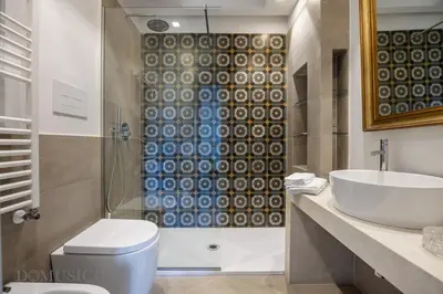a bathroom with a shower and a toilet and a sink at Palazzo Fatta Apartment by DomuSicily in Palermo