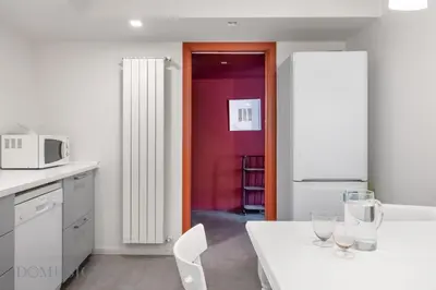 a kitchen with a table with wine glasses on it at Palazzo Fatta Apartment by DomuSicily in Palermo