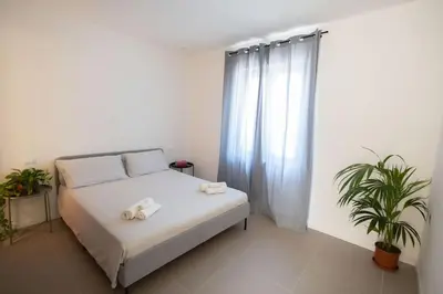 a bedroom with a bed with towels on it at iFlat Porta di Mare 49 in Palermo
