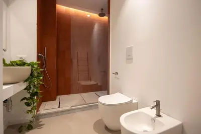 a bathroom with a toilet and a sink and a shower at iFlat Porta di Mare 49 in Palermo