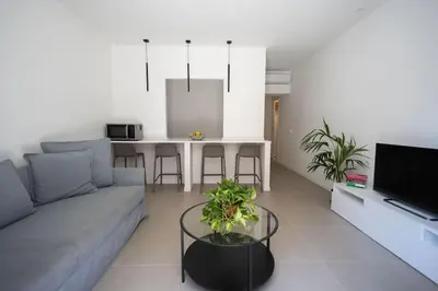 a living room with a couch and a table at iFlat Porta di Mare 49 in Palermo