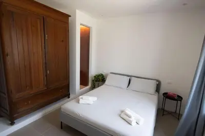a bedroom with a bed and a wooden cabinet at iFlat Porta di Mare 49 in Palermo
