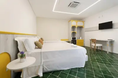 a bedroom with a large white bed and a table at B&B La Dimora di Poseidone in Bagheria