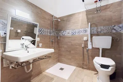 a bathroom with a sink and a shower and a toilet at B&B La Dimora di Poseidone in Bagheria