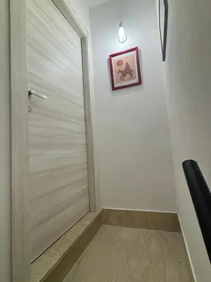 a door in a hallway with a picture on the wall at Casalabruto in Bagheria