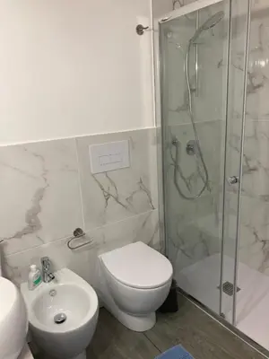 a bathroom with a shower and a toilet and a sink at Casalabruto in Bagheria