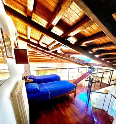 a living room with a blue couch and a slide at Villa Giovina Mondello in Mondello