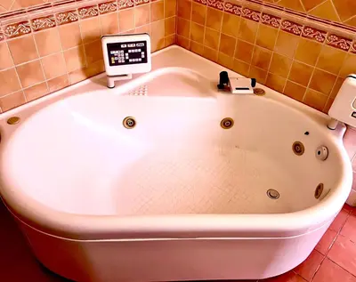 a large white bath tub in a bathroom with a monitor at Villa Giovina Mondello in Mondello