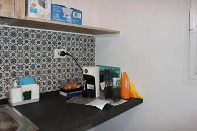 a kitchen counter with a coffee maker on it at Zia Pina Home in Palermo