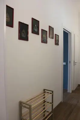 a room with a wall with pictures on it at Zia Pina Home in Palermo