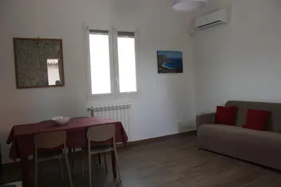 a living room with a table and a couch at Zia Pina Home in Palermo