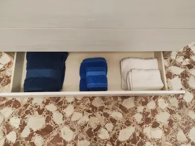 a drawer with two towels and two socks in a room at Casa Donna Caterina e Don Paolo in Bagheria