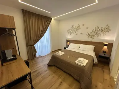 a bedroom with a bed with two towels on it at Palermo Centro Affittacamere Spina in Palermo