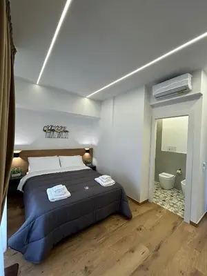 a bedroom with a large bed and a bathroom at Palermo Centro Affittacamere Spina in Palermo