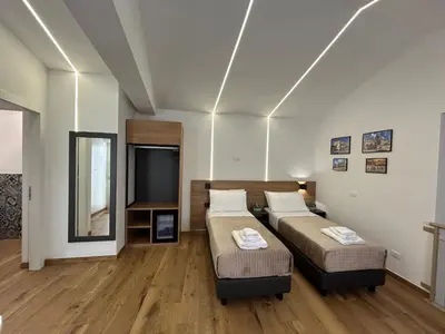 a bedroom with two beds and a television in it at Palermo Centro Affittacamere Spina in Palermo