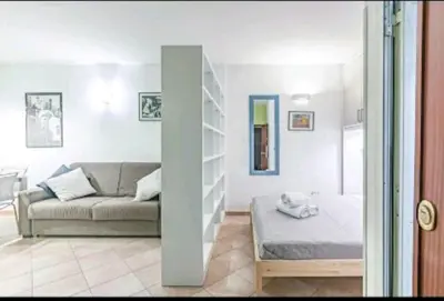 a living room with a couch and a shelf at Cappellieri Home in Palermo