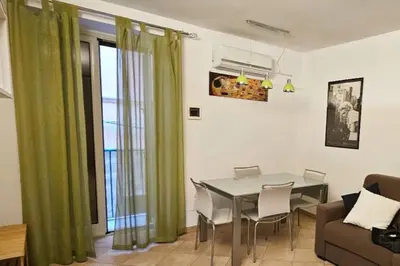 a living room with a table and a couch at Cappellieri Home in Palermo