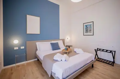 a bedroom with a bed with two towels on it at Politeama Charming Apartment in Palermo