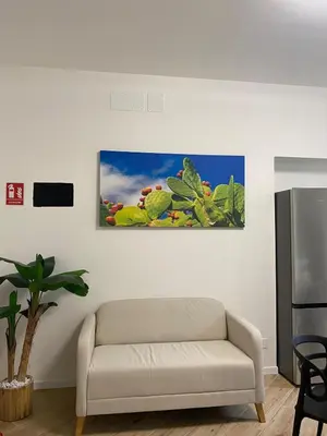 a living room with a couch and a refrigerator at LB SilvioCentro in Palermo