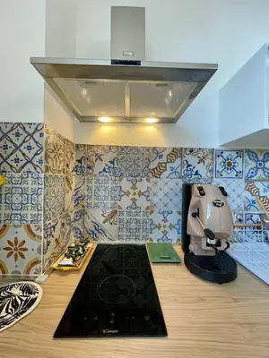 a kitchen with a mixer on a counter with tiles at LB SilvioCentro in Palermo