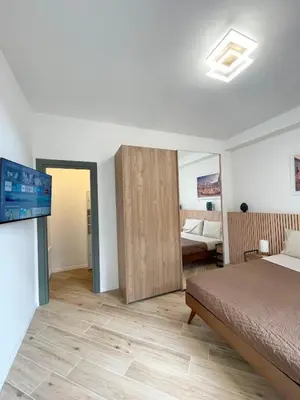 a bedroom with a bed and a room with a television at LB SilvioCentro in Palermo