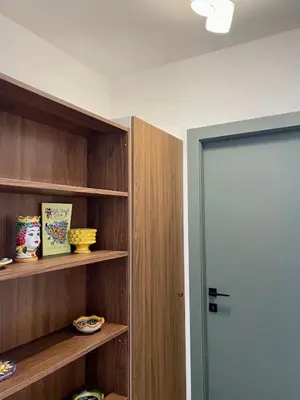 a room with wooden shelves and a door to a room at LB SilvioCentro in Palermo