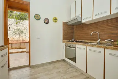 a kitchen with a white refrigerator and a microwave at Where The Sun Rises in Scopello