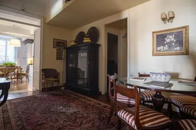 a living room with a dining room table and chairs at Palermo 3 bedrooms apartment historic center in Palermo