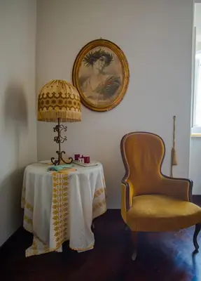 a table with a lamp and a chair in a room at Palermo 3 bedrooms apartment historic center in Palermo