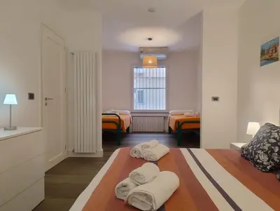 a bedroom with two towels on a bed at Lollo's Terrace Panoramic View in Palermo