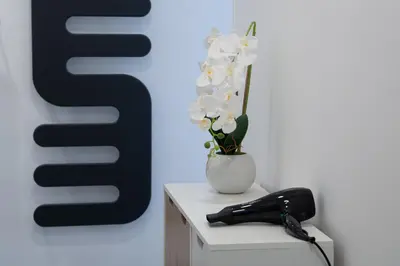 a telephone and a vase with flowers on a table at Lollo's Terrace Panoramic View in Palermo