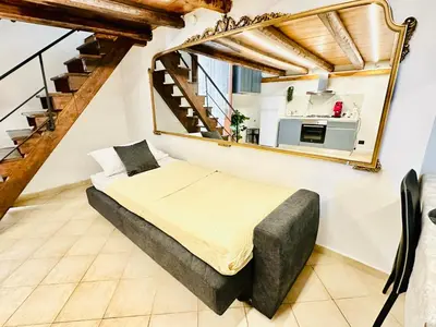 a bedroom with a bed and a mirror at Siloe Apartment Palermo in Palermo