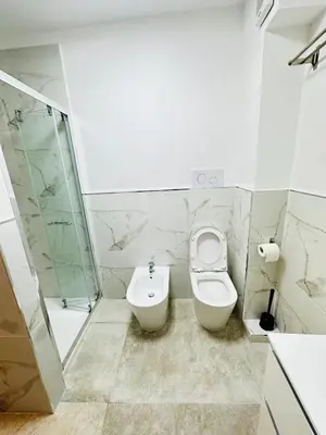 a bathroom with a toilet and a sink at Siloe Apartment Palermo in Palermo
