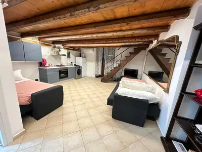 a large room with a bed and a kitchen at Siloe Apartment Palermo in Palermo