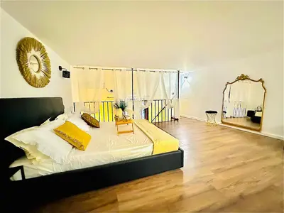 a bedroom with a large bed and a mirror at Siloe Apartment Palermo in Palermo