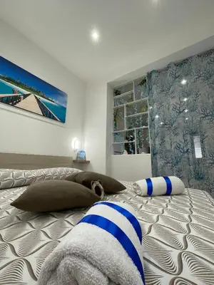 a dog laying on a bed in a bedroom at La Casetta di Isola in Isola delle Femmine