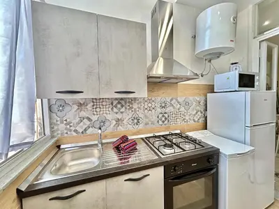a kitchen with a sink and a stove top oven at Casa Esterù -Centro storico di Palermo- in Palermo