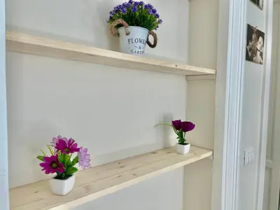 two flowers on a shelf in a room at Casa Esterù -Centro storico di Palermo- in Palermo