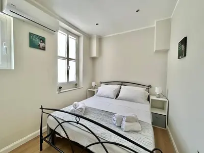a bedroom with a bed with towels on it at Casa Esterù -Centro storico di Palermo- in Palermo